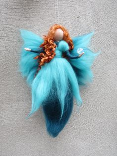 a blue and orange doll hanging from a string