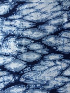 an image of blue and white marbled paper with water droplets on it's surface