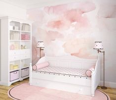 a baby's room with pink watercolor paint on the wall and white furniture