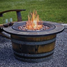 a fire pit sitting on top of a gravel field