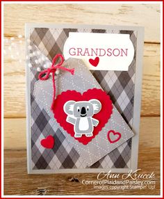 a handmade card with a koala bear on it and a red heart hanging from the front