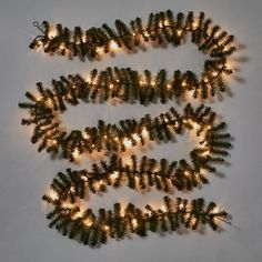 several pine cones are arranged in the shape of letters that spell out's spelled with lights