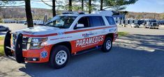 an ambulance is parked on the side of the road in front of a parking lot