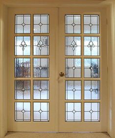 the front door is decorated with glass panels