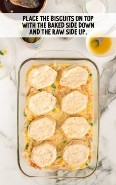 a casserole dish with biscuits on top and the words, place the biscuits on top with the baked side down and the raw side up