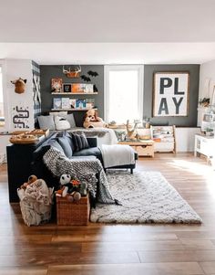 a living room filled with lots of furniture and decor on top of a hard wood floor