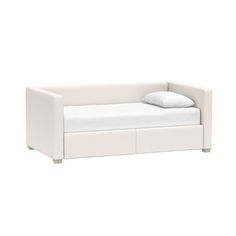 a white day bed with two pillows on it