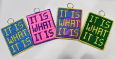 three different colored patches with the words it's what she is and its written on them