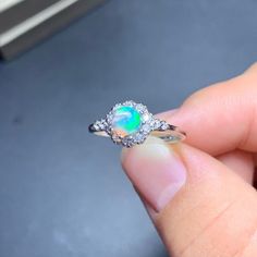 Diamond White Round Opal Jewelry, Ethiopian Opal Ring For Wedding, Opal Jewelry With Halo Setting For Gift, Diamond White Opal Ring Fine Jewelry, Round Opal For Jewelry Making, Ethiopian Opal Birthstone Jewelry, Opal Ring With Cubic Zirconia Accent Stones For Gift, Opal Gemstone Crystal Ring For Anniversary, Opal Crystal Ring For Anniversary