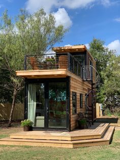 a small wooden house sitting on top of a lush green field