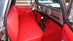 the interior of an old car with red leather seats