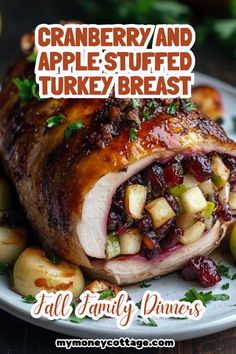 a turkey breast with cranberry and apple stuffing on it sits on a white plate