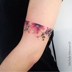 a woman's arm with pink flowers on it