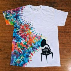 a t - shirt with an image of a record player on top of a table