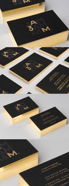 several black and gold business cards are arranged in the shape of letters on top of each other