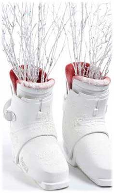 two white snow boots with branches in them