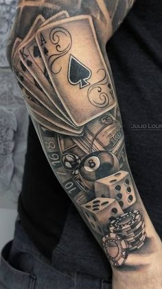 a man's arm with playing cards and dice on it