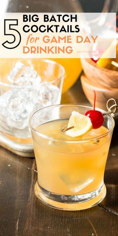 a close up of a drink in a glass on a table with ice and lemons