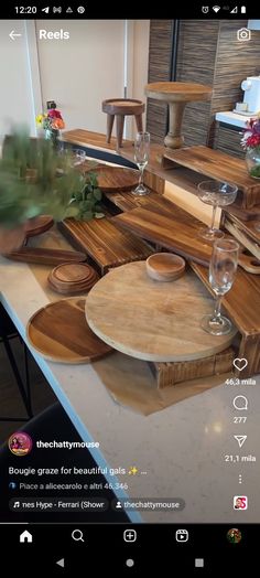 an image of a kitchen counter top with wine glasses and plates on the countertop