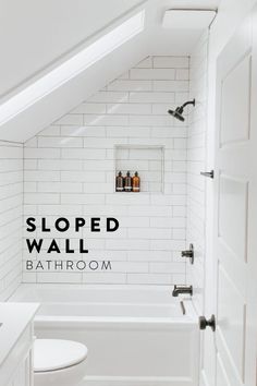 a white bathroom with the words sloped wall above it