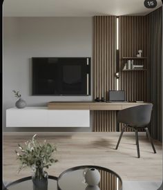 a living room with a large television on the wall next to a table and chairs