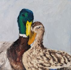 two ducks sitting next to each other on a blue and white background, one with yellow beaks