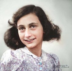 an old photo of a young woman with dark hair and blue eyes smiling at the camera