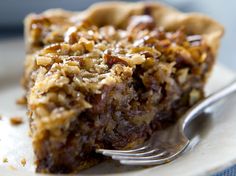 a close up of a piece of pie on a plate with a fork in it