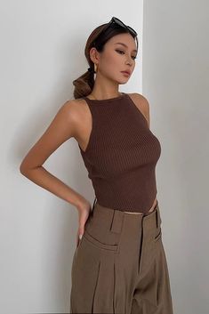 Trendy Non-stretch Sleeveless Top, Brown Sleeveless Stretch Halter Top, Brown Stretch Sleeveless Tank Top, Solid Color Sleeveless Top, Brown Stretch Halter Neck Tank Top, Brown Stretch Halter Neck Crop Top, Brown Stretch Sleeveless Crop Top, Non-stretch Ribbed Sleeveless Tops, Ribbed Non-stretch Sleeveless Top