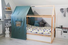 a child's bed with a tent on top of it