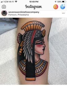 a woman's arm with an egyptian head tattoo on the left side of her body