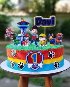 a birthday cake with paw patrol figures on it