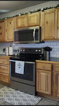 a kitchen with wooden cabinets and stainless steel appliances