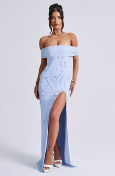 Milani is one of our dreamiest designs of the season. perfect for chasing sunsets and beyond. This maxi dress is soft girl perfection. made in a delicate mesh with playful 3D flower appliques and bardot neckline to show off your shoulders. The dress is complete with a thigh high split and open low back. Colour: Blue.Premium stretch mesh.Fully lined.3D floral appliques.Bardot neckline.Strap detail at back.Cut out low back.</ Cut Out Prom Dresses, Homecoming Dresses Corset, Blue Long Dress, Midi Dress Wedding Guest, Chasing Sunsets, Bardot Neckline, Maxi Dress Sale, Girly Dresses, Winter Formal