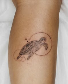 a small turtle tattoo on the leg