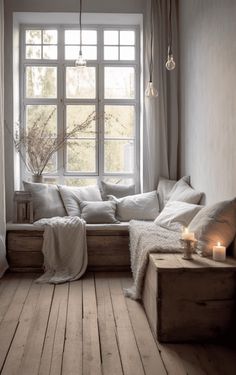 a living room filled with lots of furniture and pillows on top of a wooden floor