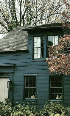 a blue house with green trim and windows