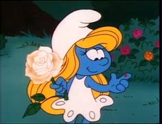 the smurf is holding a rose in her hand and pointing to it's left