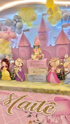 there are many princess figurines on display in front of the cake and balloons