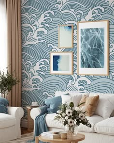 a living room with blue and white wallpaper, two couches and a coffee table