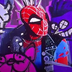 a man in a spiderman suit holding a skateboard with other graffiti on the wall behind him