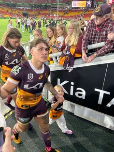 the rugby players are walking out onto the field