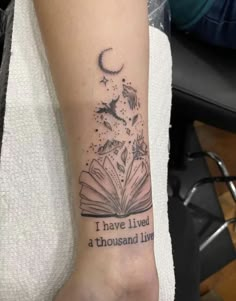 a person with a book tattoo on their arm