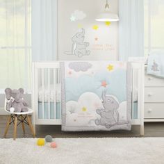 a baby crib bedding set with an elephant and stars design on the side