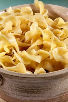 a bowl filled with pasta sitting on top of a table