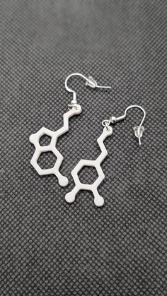 Add a touch of science to your style with our 3D-printed Serotonin and Dopamine Earring Set! These lightweight earrings, standing at 1 1/4" tall, are available in bold colors like white, black, blue, pink, orange, and green. Perfect for anyone who loves unique, chemistry-inspired accessories, these earrings are a fun way to show off your love for brain chemistry while staying on-trend. Ideal for gifting or personal wear, they are an exciting blend of modern fashion and scientific flair. Shop now for your custom Serotonin and Dopamine earrings! ** The earrings in the photo are shown in jade white ** Select the color you want when checking out! Science Fashion, 3d Earrings, 3d Printed Earrings, Brain Chemistry, Orange And Green, Lightweight Earrings, Earrings Unique, Light Weight Earrings, North East