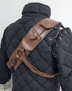 the back of a man's jacket with leather straps