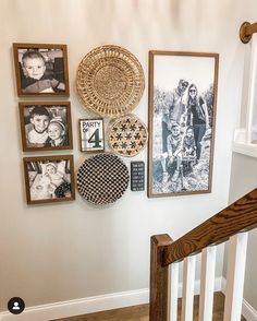 a staircase with pictures and photos on the wall next to wooden bannister railing