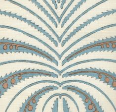 an intricate blue and brown design on white fabric