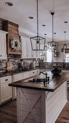 a large kitchen with white cabinets and wooden counter tops, along with an island in the middle